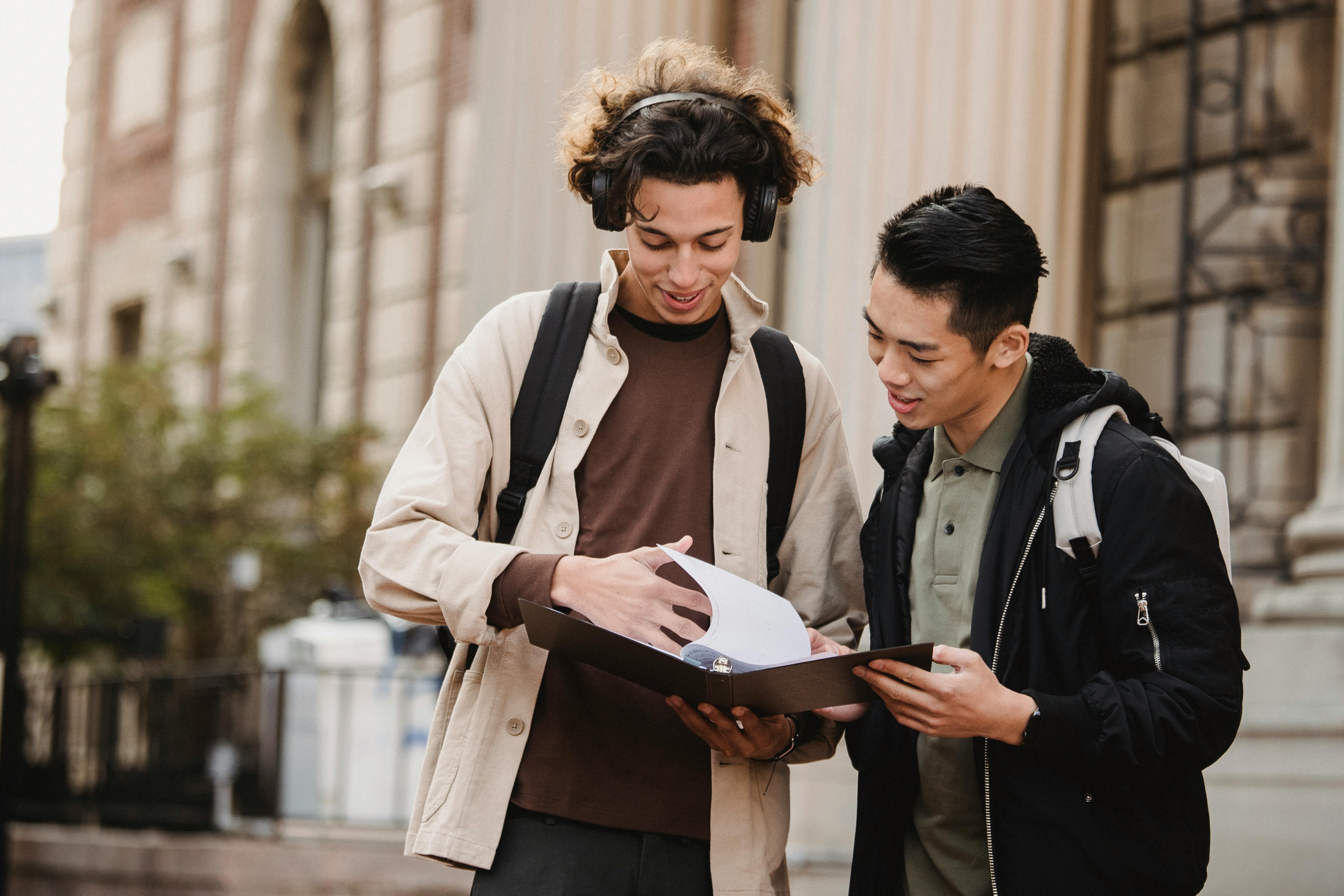 Two university students sharing notes.